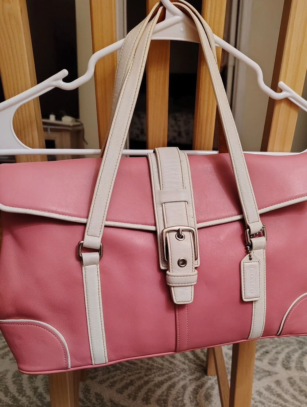 Coach Pink Shoulder Bag with White Trim and Buckle Detail.